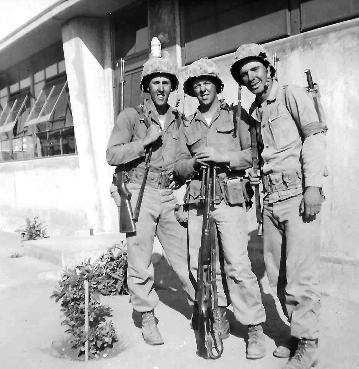 Three U.S. Marines ready to head to Korea in 1950, armed with M1 Garands and a Model 1918A2 BAR.